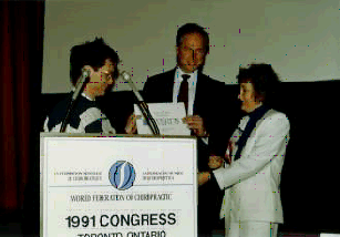 Dr. Scott Haldeman, Chair, WFC Research Council (middle), and Dr. Jean Moss, President, Canadian Memorial Chiropractic College (right) present a Research Award to Bart Koes, MA of the Netherlands at the 1st Biennial Congress in Toronto